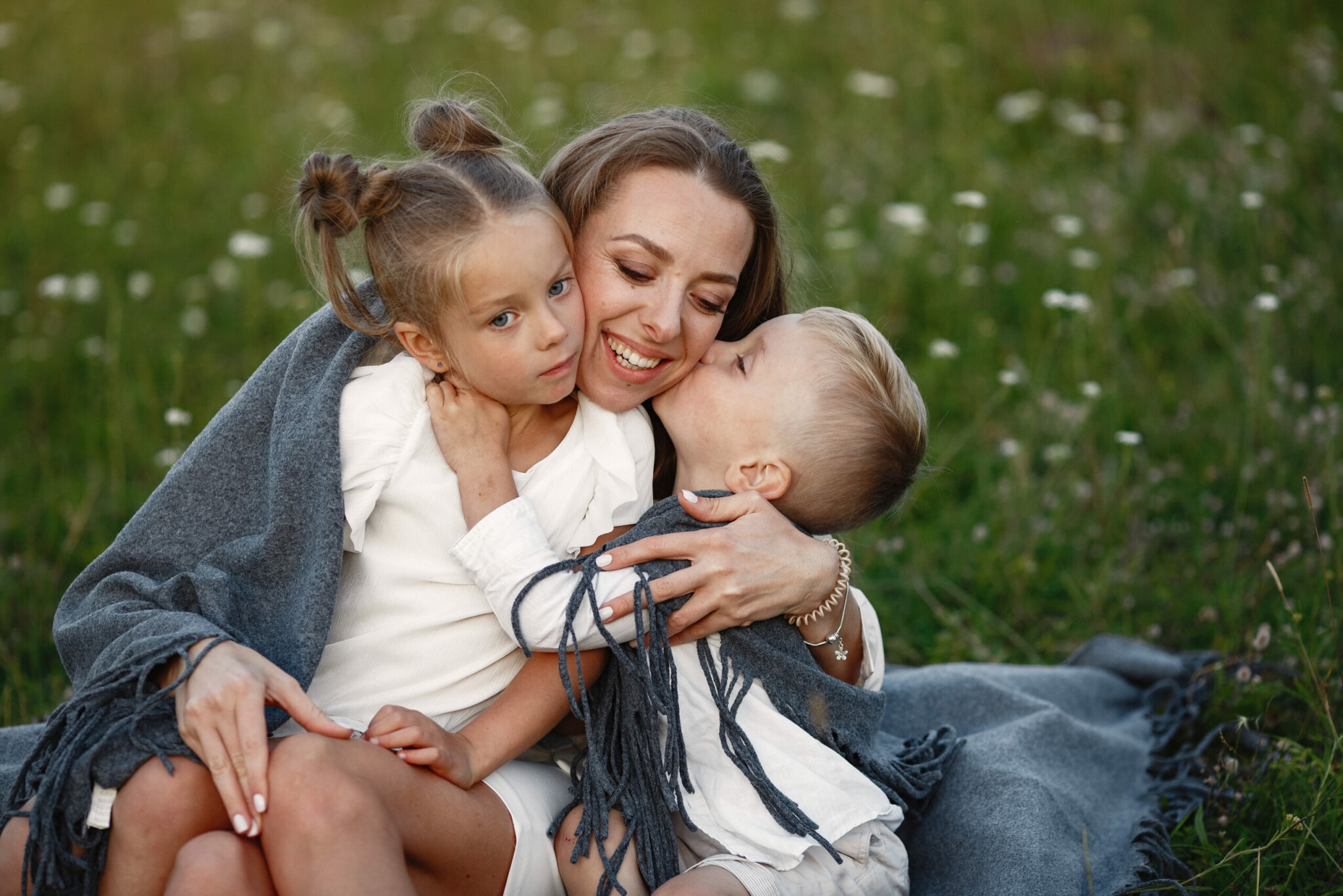 Le bonheur simple d'une maman faisant un gros câlin à ses enfants qu'elle prend dans ses bras