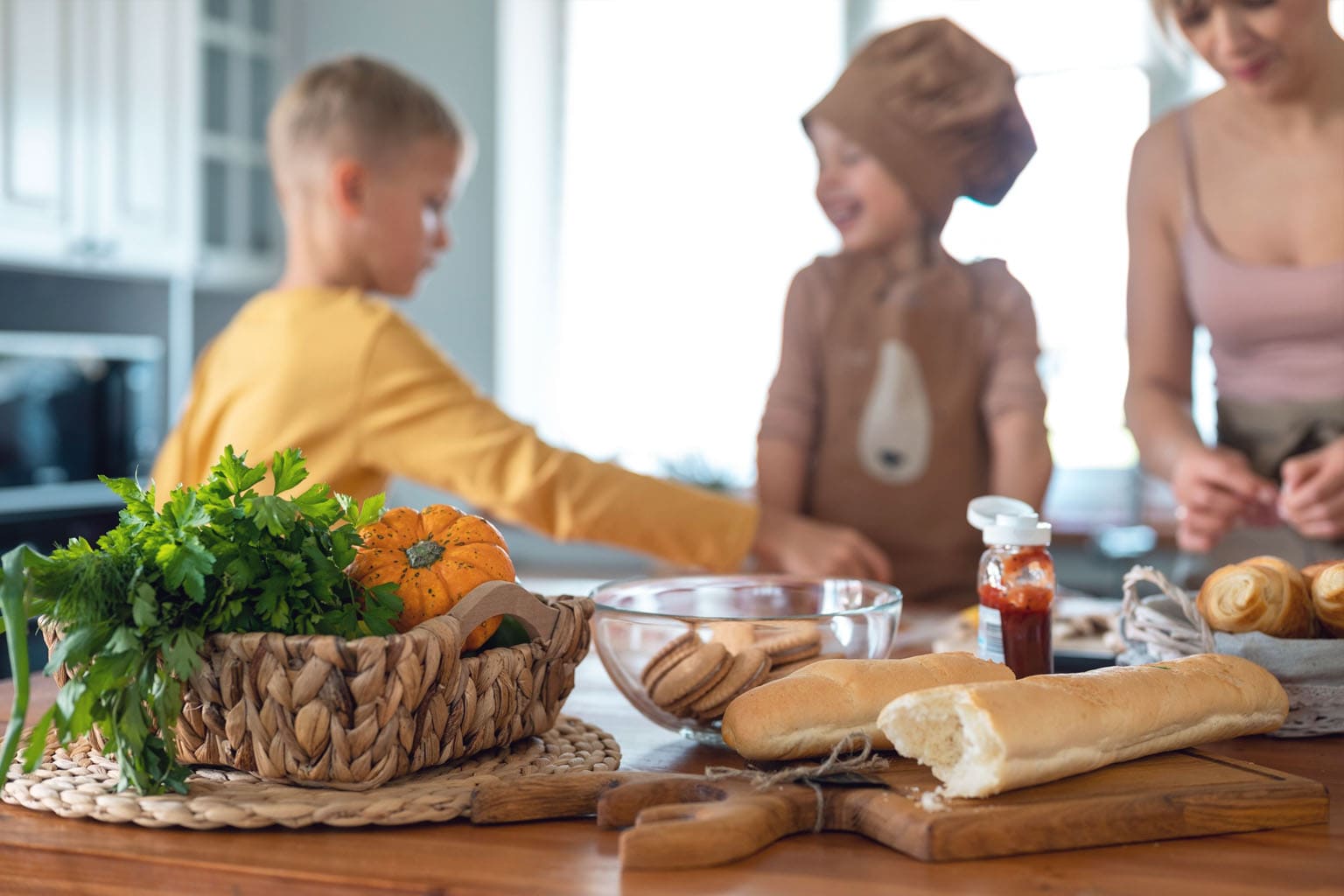 Maman et enfants qui cuisinent ensemble un repas du mercredi à la maison